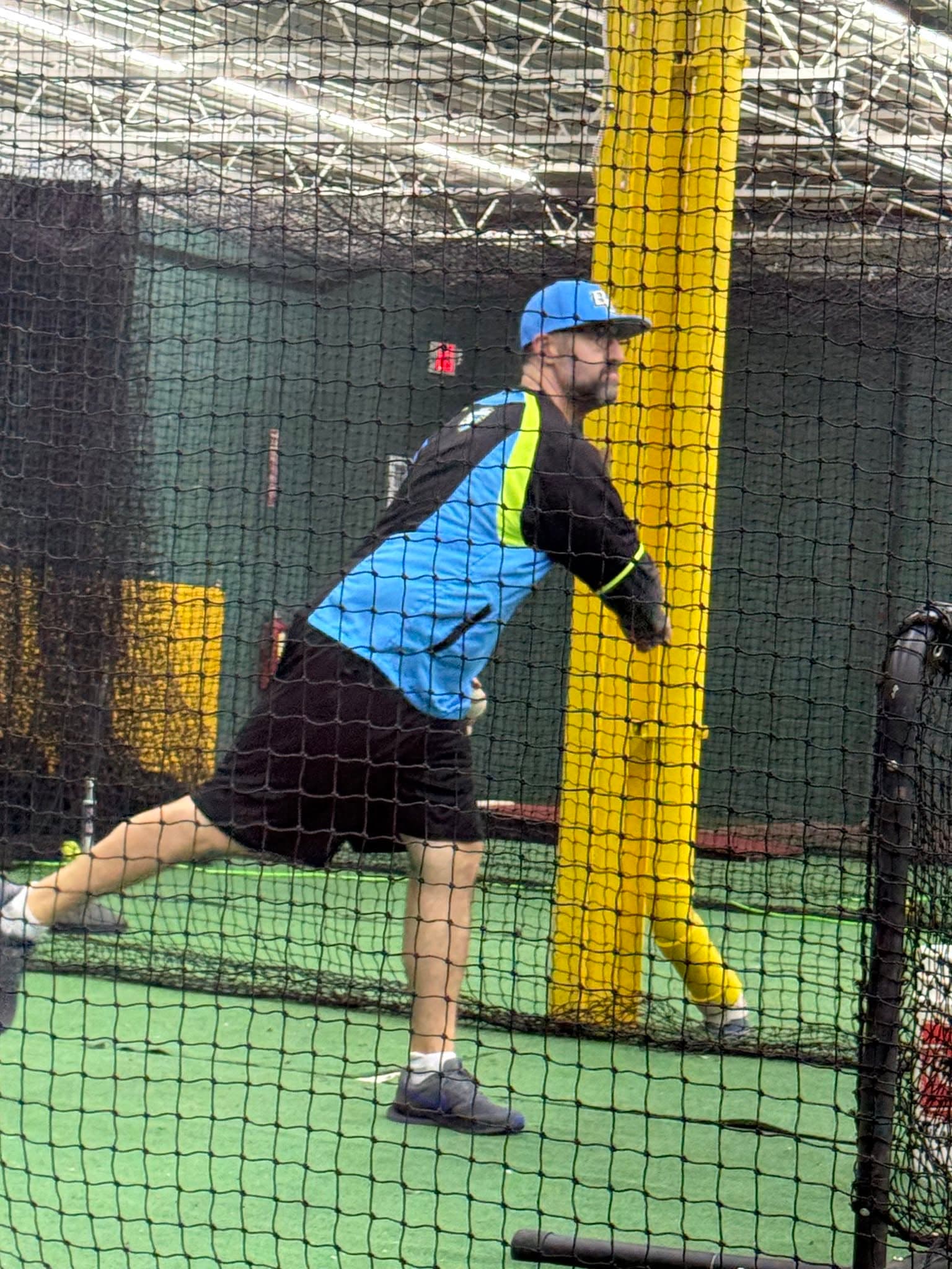 Coach Kyle Richardson training in the batting cage